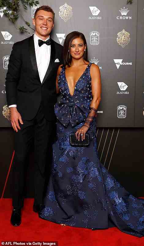 Patrick Cripps of the Blues and Monique Fontana struck a pose on the red carpet but Monique's navy blue dress with a v-neckline and a large bow on the front (as well as a train) had far too much going on and was distracting to the eye