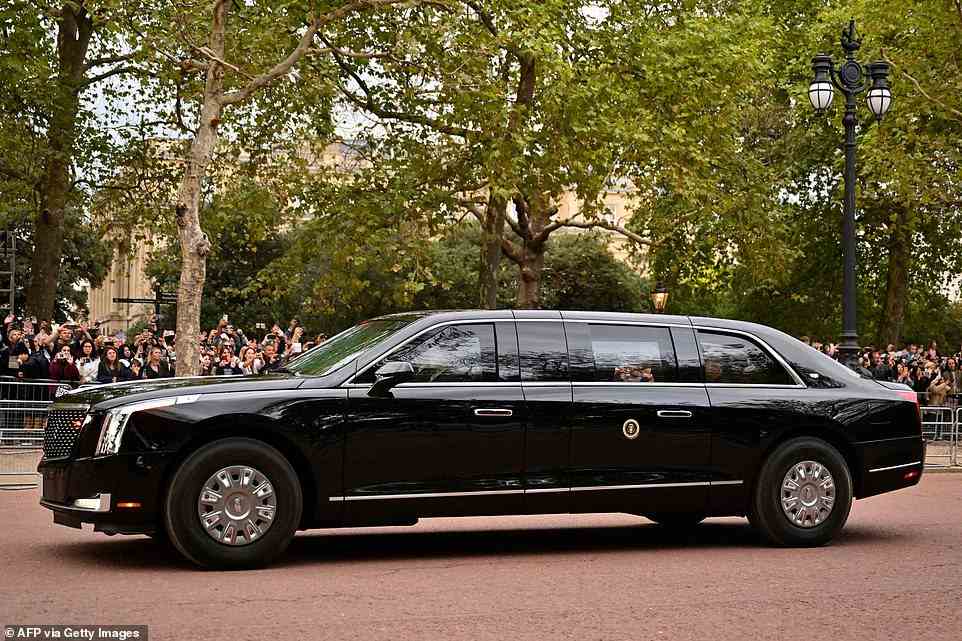 US President Joe Biden sits in his car "The Beast" as it passes by Buckingham Palace this evening