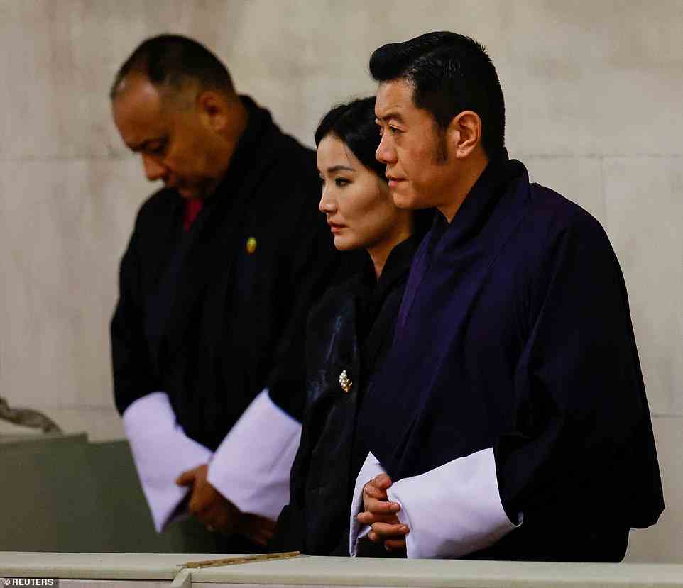 Bhutan's King Jigme Khesar Namgyel Wangchuck (right) and Queen Jetsun Pema (middle) pay their respects to the Queen during her lying-in-state at Westminster Hall