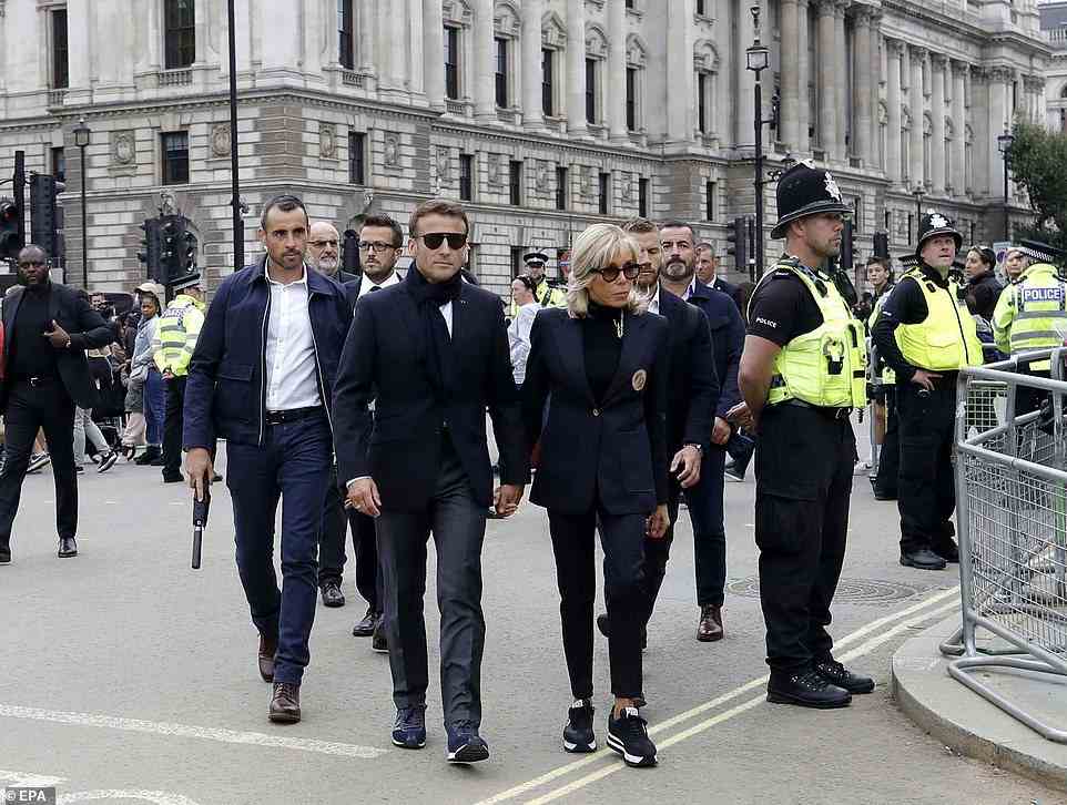 French President Emmanuel Macron (C-L) and his wife Brigitte Macron (C-R) arrive at Westminster Hall to pay their respects to Britain's late Queen Elizabeth II in London, Britain, 18 September 2022. The queen's funeral will be held on 19 September, following four days of lying in state inside Westminster Hall