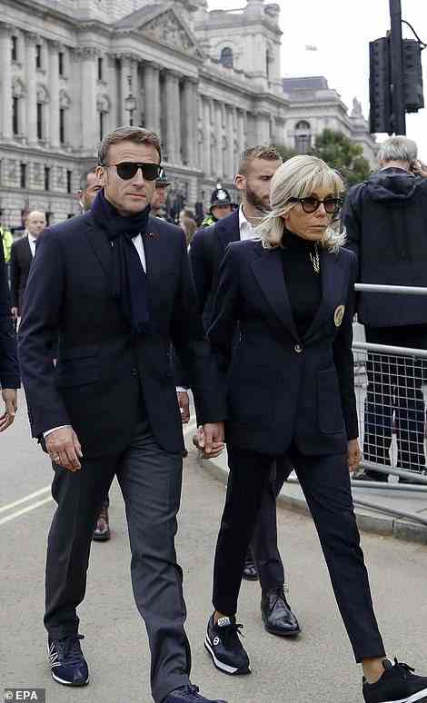 French President Emmanuel Macron (L) and his wife Brigitte Macron (R) arrive at Westminster Hall to pay their respects to Britain's late Queen Elizabeth II
