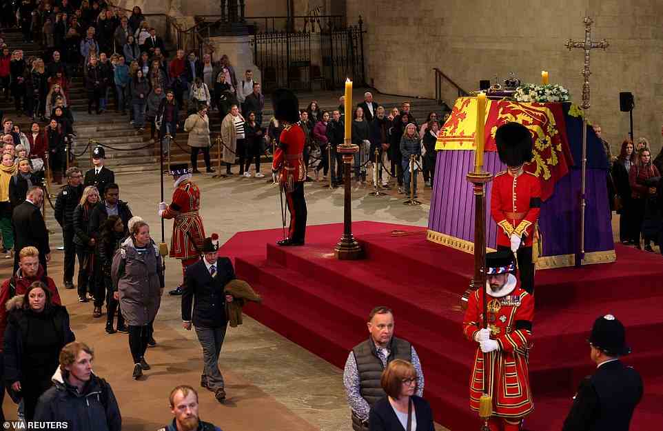Members of the public pay their respects as they pass the coffin of Queen Elizabeth II, Lying in State inside Westminster Hall, at the Palace of Westminster in London on September 18, 2022