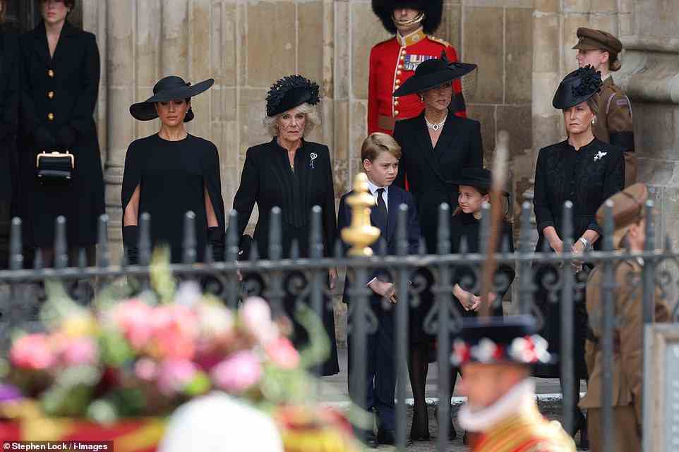 The Duchess of Sussex, Queen Consort, Princess of Wales and Sophie Wessex put on a united front as they stood outside the Abbey with Prince George and Princess Charlotte