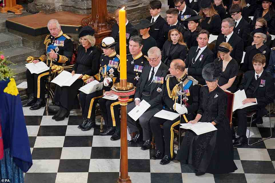 Distraught members of the royal family looked sombre as the Queen's coffin was laid to rest in front of them for the ceremony tosay