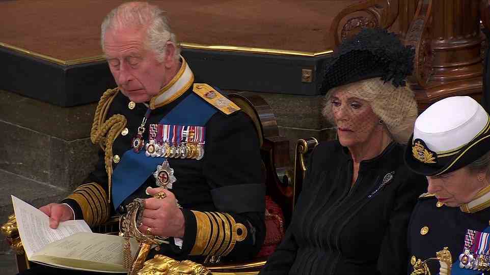 King Charles III was seen holding on to his sword as he listened to the Bible reading during his mother's funeral at Westminster
