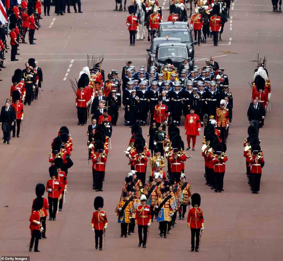 The funeral procession marches down The Mall following the service at Westminster Abbey, on the day of the state funeral and burial of Britain's Queen Elizabeth. Her children and grandchildren followed with other royals in their cars