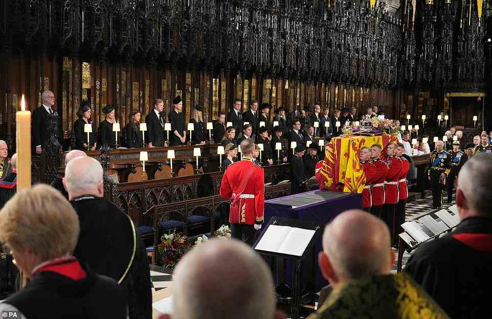 The coffin of Queen Elizabeth II is carried into St George's Chapel along the centre aisle of the nave to the catafalque