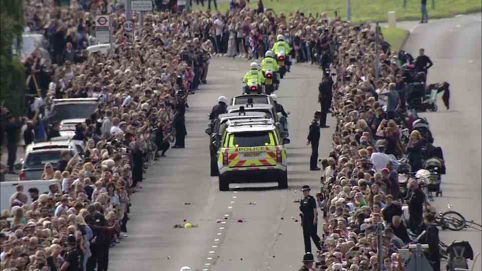Huge crowds cheer the Queen and throw flowers in her path