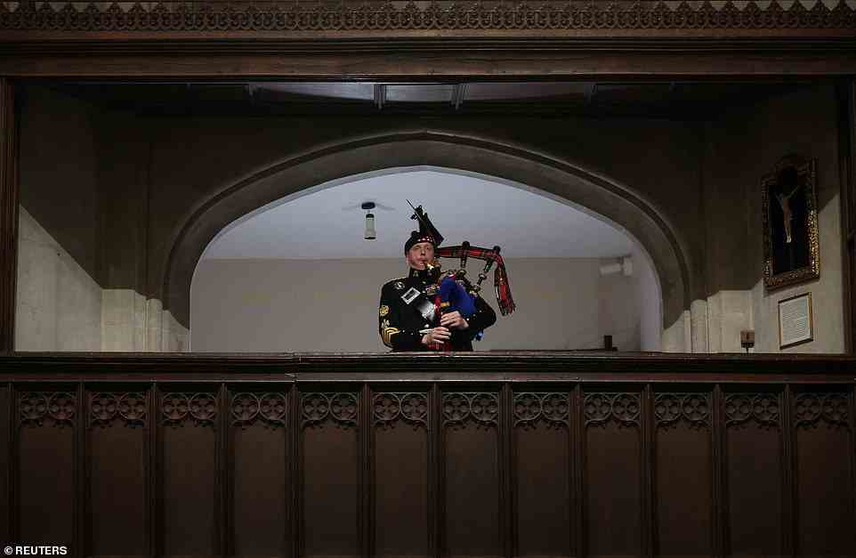 A piper plays a lament for the Queen at the end of the service