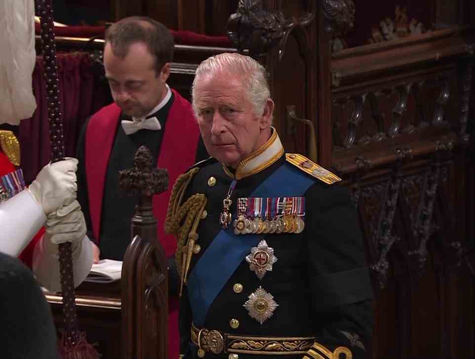 An emotion King Charles arrives in the Abbey after the Queen is placed by the altar