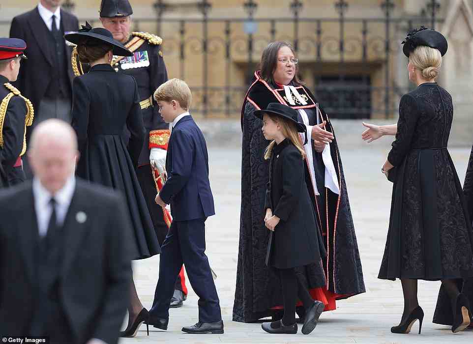 A nervous Prince George makes his way into Westminster Abbey alongside his mother, as his sister Princess Charlotte follows behind
