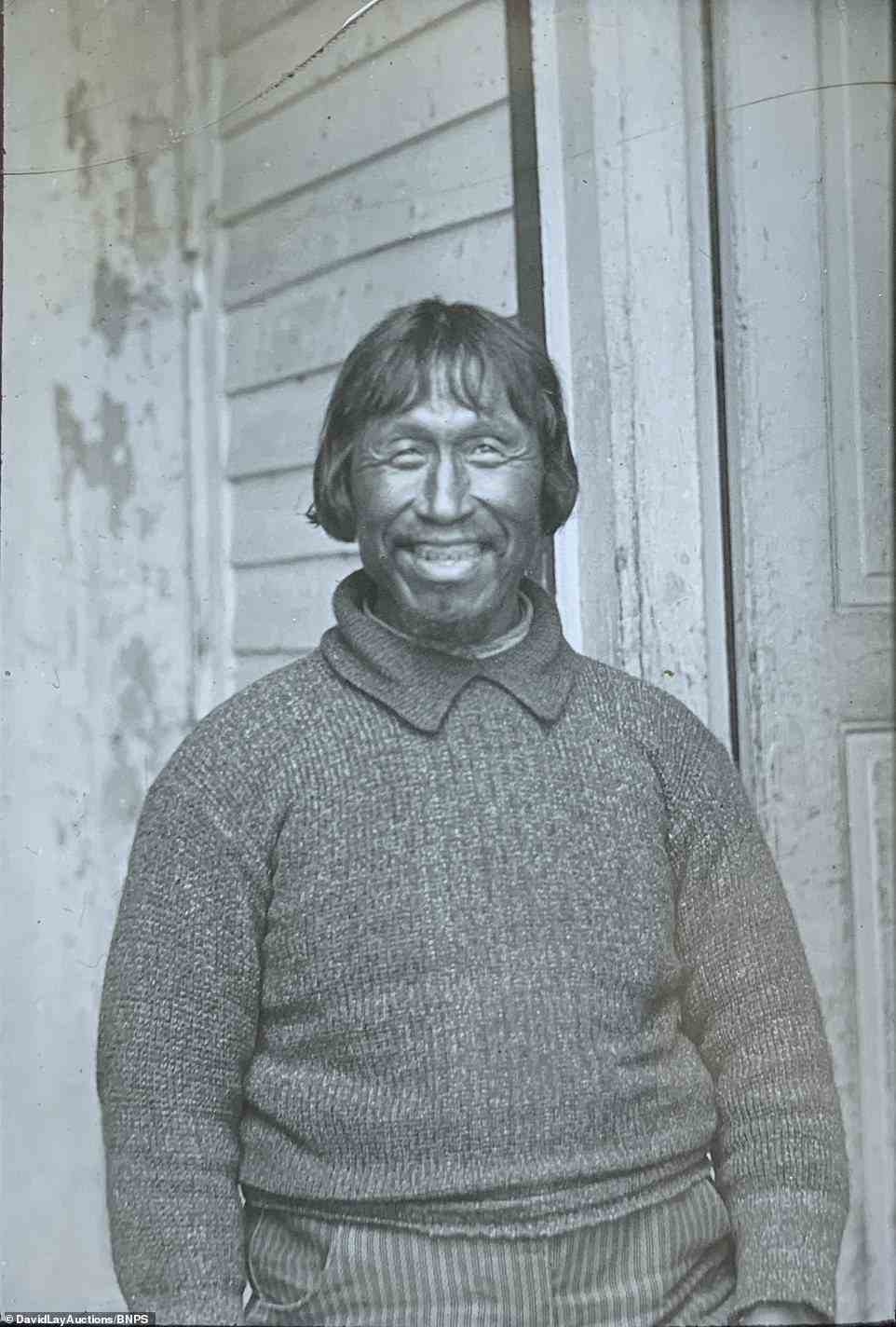 A smiling portrait of an Inuit man taken before communities were threatened by the Spanish Flu pandemic