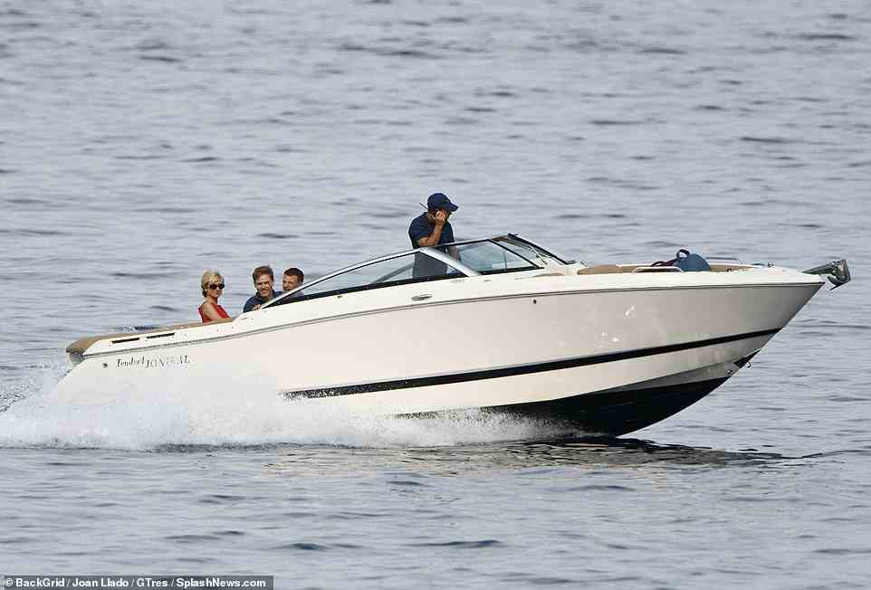 Riding the waves: The group beamed as they zipped along rthe water on the speedboat