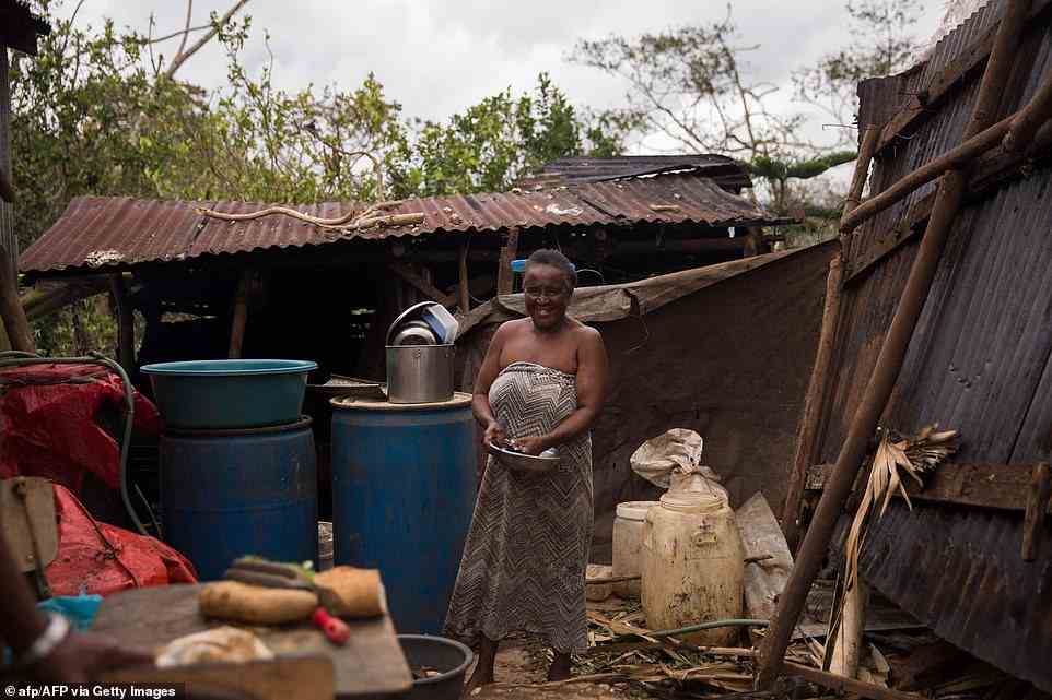 A woman washes the dishes in a house near the highway connecting Miches with El Seibo in the northeast of the Dominican Republic