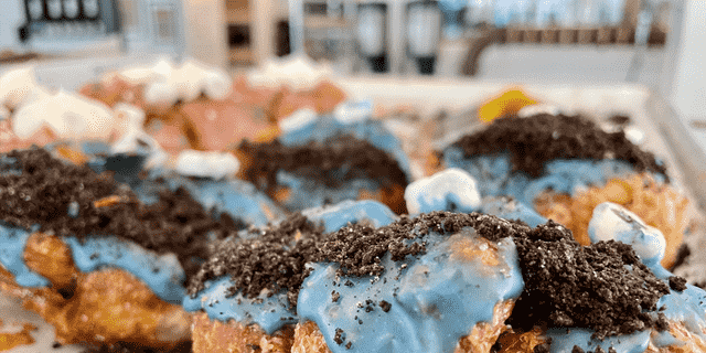 Parlor Donuts in Nashville offers an incredible array of delicious and colorful breakfast treats, including its Cookie Monster donuts with blue frosting and white marshmallow eyes.