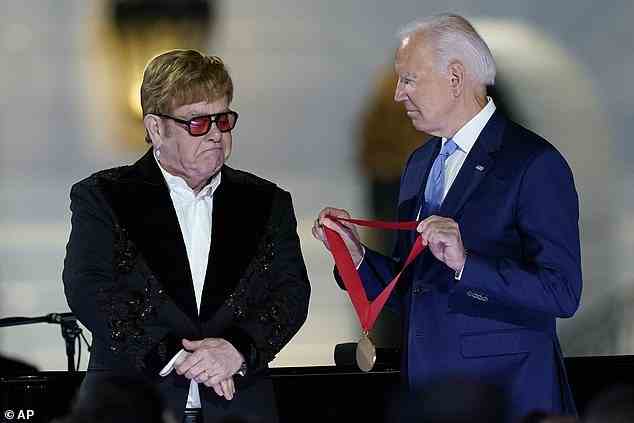 President Joe Biden presents Elton John with the National Humanities Medal after a concert on the South Lawn of the White House in Washington