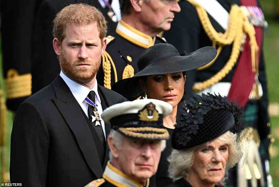 Prince Harry had insisted on having his wife, Meghan, with him on the day the Queen died, but she was banned from attending by King Charles III, it is alleged. Pictured: The Duke and Duchess of Sussex stand behind King Charles and Queen Consort Camilla at Queen Elizabeth II's funeral on September 19