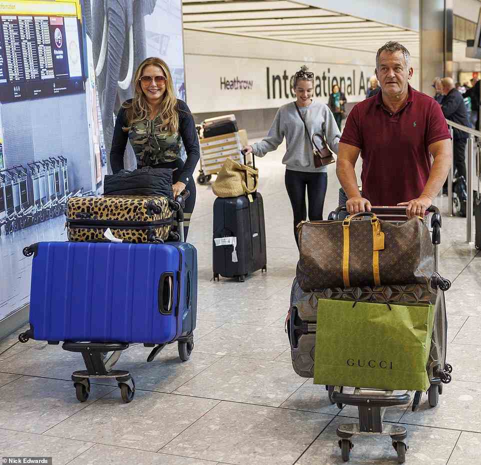 Luggage: Elsewhere Paul dressed down in a dark red T-shirt and grey joggers as he strolled through the airport