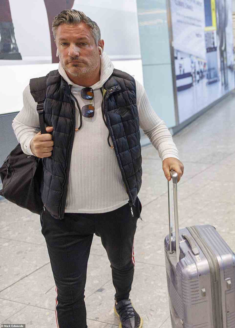 Celebrities: Dean Gaffney was also spotted at Heathrow and wore a gilet and white top
