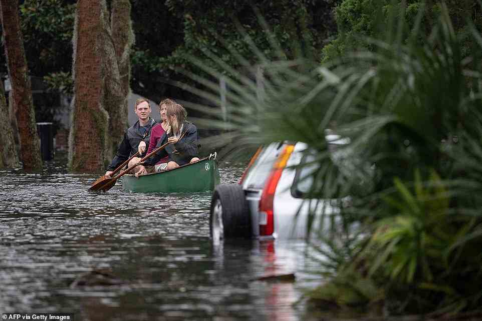 ORLANDO: People paddle by in a canoe next to a submerged car in the aftermath of flash flooding in an attempt to get to safety