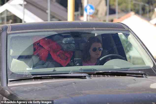 A Russian girl is seen driving to the border with a car packed full of her belongings (pictured)