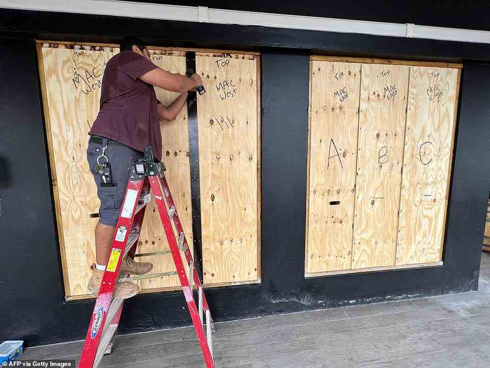A man in Hamilton, Bermuda was seen boarding up a business as the threat of Hurricane Fiona lingers. The storm is currently a Category 4 threat and is swiftly moving towards Bermuda with winds up to 135mph