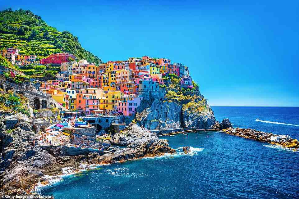 Gelato tones: Fiona McIntosh found that Italy's Cinque Terre, the dramatic stretch of coast at the tail-end of the Italian Riviera, tucked away between Genoa and Pisa, offers 'a slice of perfect Italian authenticity'. Above is pretty Manarola, one of Cinque Terre's five villages