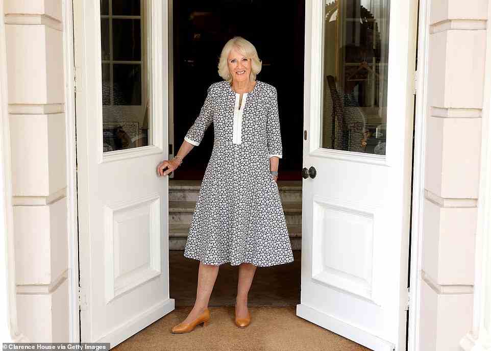 The Queen Consort sought refuge at Ray Mill House, in Wiltshire, during a break from official duties yesterday. Pictured, Camilla standing in the impressive front doors to the property, in a photo taken to mark her 75th birthday
