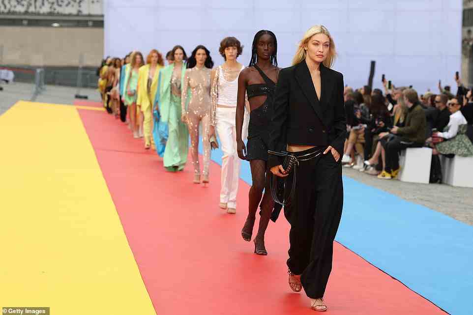 Walk this way: Gigi looked sensational as she led her fellow models down the multicoloured runway in Paris