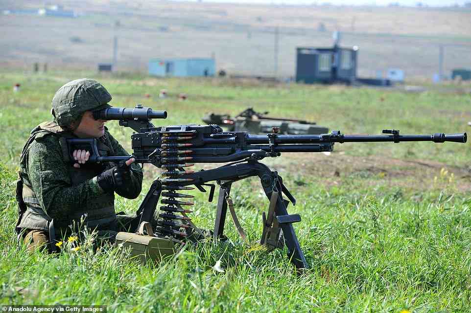 A Russian reservist, called up as part of Putin's mobilisation order, practices firing a heavy machine-gun at a range in the Rostov region before being deployed into combat