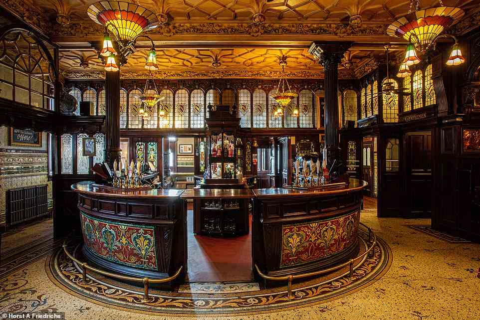 PHILHARMONIC DINING ROOMS, LIVERPOOL: This beautiful Grade I-listed establishment is 'a place lauded by heritage body Historic England as "a cathedral among pubs" and "the pinnacle of the gin palace"', the book reveals. The pub, which was built between 1898 and 1900, is described by the tome as a 'phantasmagoria of High Victoriana, from its turreted, gabled and oriel-windowed castle-like exterior... to an interior that puts a melange of imposing styles – Gothic, classical, Jacobean, Romanesque, Scots baronial – into a giant blender’. Even the gents’ loos are eye-catching, with ladies apparently regularly lining up to peek at their ‘rose-pink faux-marble 1890s “Rouge Royale” urinals’ and ‘glinting mosaics’. Such is the pub’s allure that John Lennon was moved to claim that 'the principal price of fame' was 'no longer being able to have a pint in the Phil'