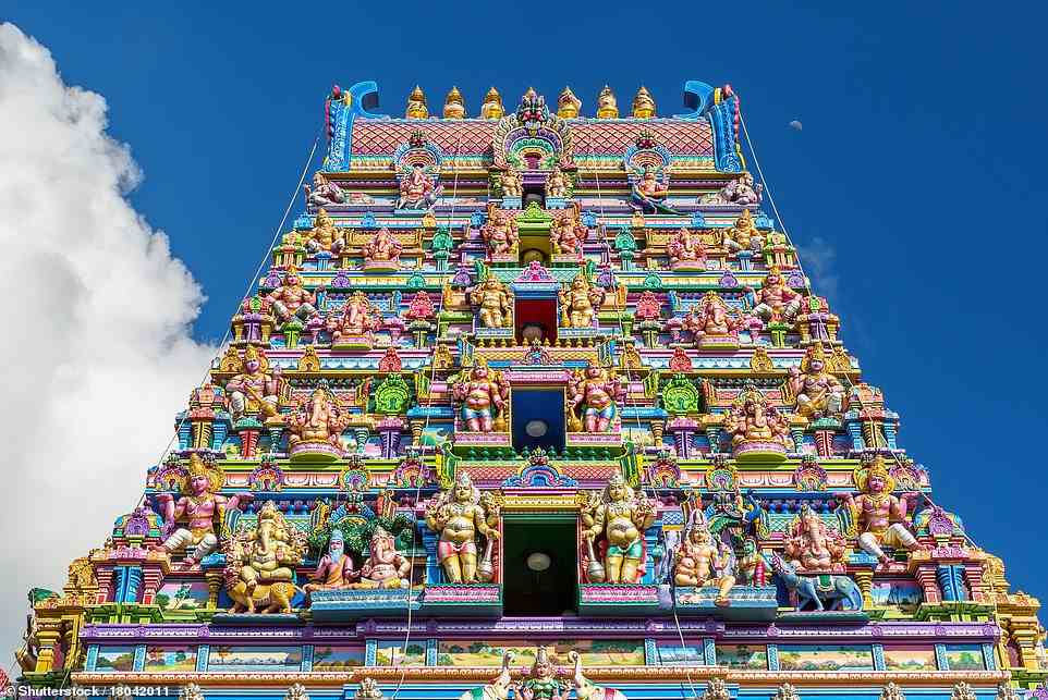Above is the 'extravagant, pastel-coloured' Sri Navasakthi Vinayagar Hindu temple that 'looms over' Victoria