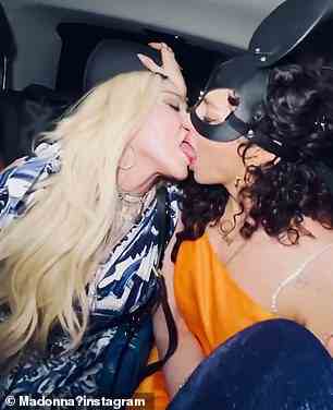 Geburtstags-Smooches: Die Queen of Pop teilte auch Schnappschüsse von sich selbst, als sie zwei Frauen auf dem Rücksitz eines Autos küsste, während sie Anfang dieses Jahres ihren 64. Geburtstag in Italien feierte