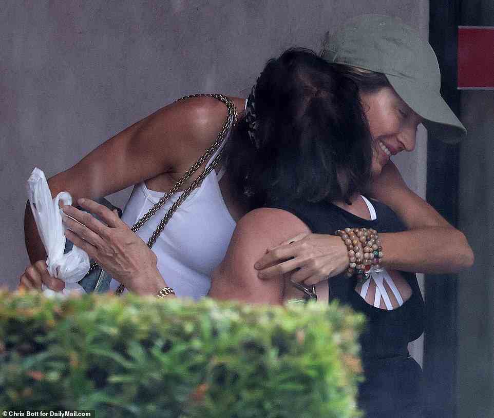 The pair shared a warm embrace after their lunch, before the supermodel dashed out into the pouring Miami rain