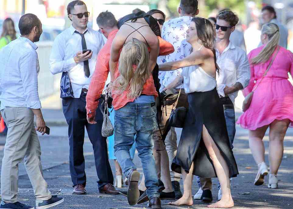 Punters celebrate and loosen their ties after a busy Saturday afternoon in Randwick watching the horse races