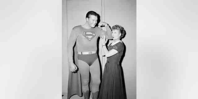 American actor George Reeves (1914-1959) flexes his biceps while actress and comedian Lucille Ball touches his muscle during the episode "Lucy and Superman" in Hollywood, Calif., Nov. 15, 1956. 