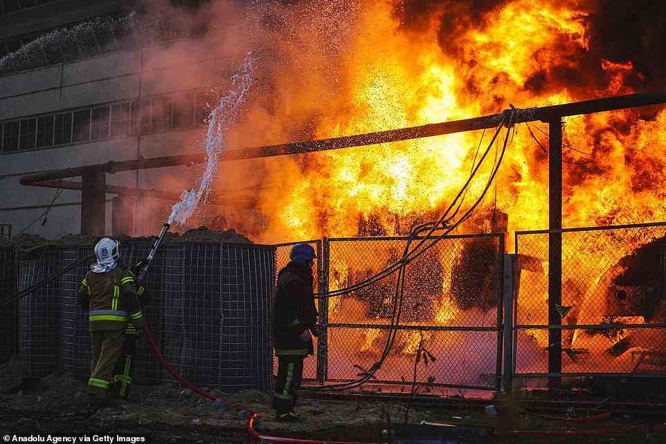 Members of emergency services respond to a fire after a Russian attack targeted energy infrastructure in Kyiv
