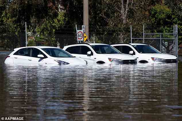 Cars are submerged in floodwaters after heavy rain was dumped over Shepparton, in Victoria, on Monday