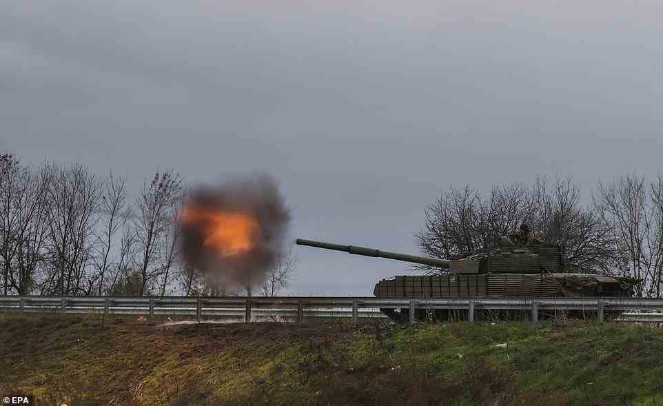 epa10269650 Ukrainian servicemen shoot from the seized Russian T-80 tank on a road near the city of Bakhmut, Donetsk