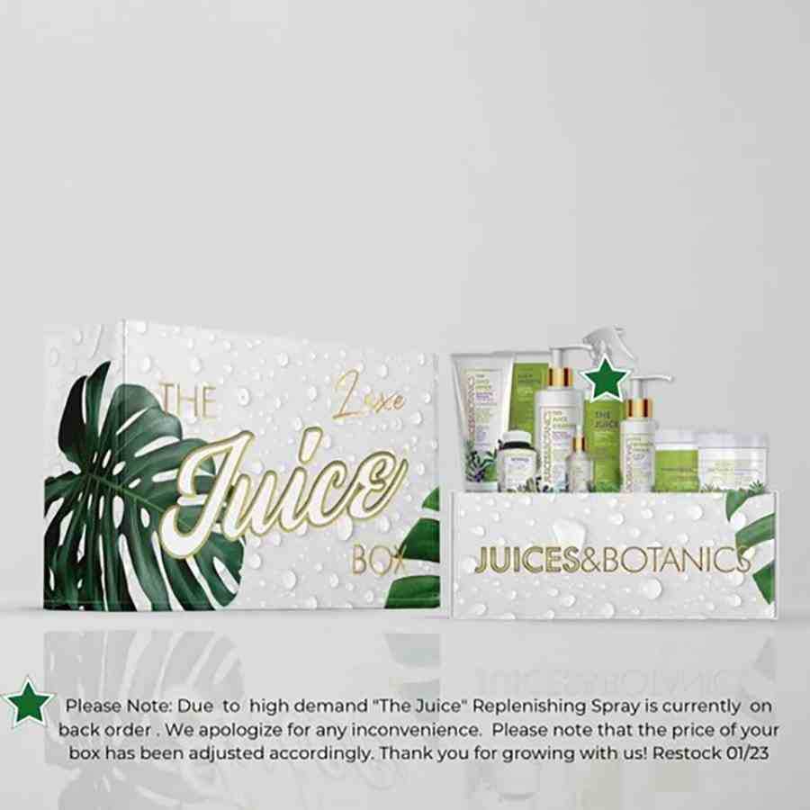 Säfte & Botanik Die Juice Box Luxuriöse Schachtel mit grünen und weißen Haarprodukten in einer mit Wassertropfen bedruckten Schachtel auf grauem Hintergrund