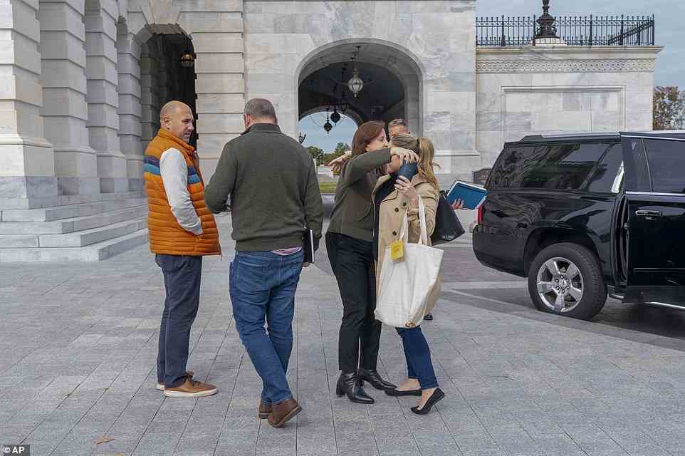 Staff members of House Speaker Nancy Pelosi, including Pelosi's Chief of Staff Terri McCullough, second from right, hug outside of the Capitol on Friday