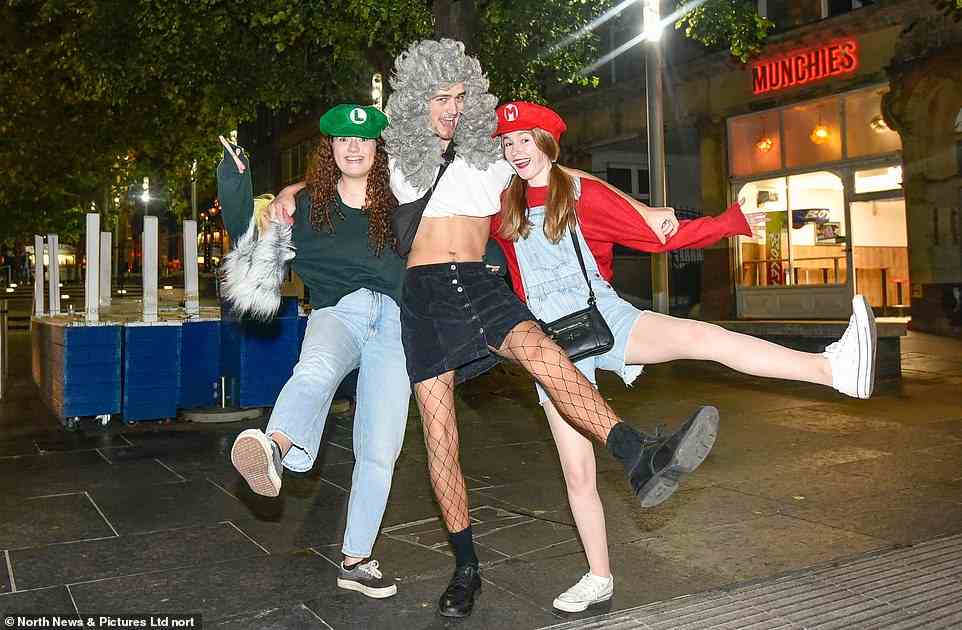 Two girls dress up as Mario and Luigi while a man sports a striking grey wig in Newcastle city centre