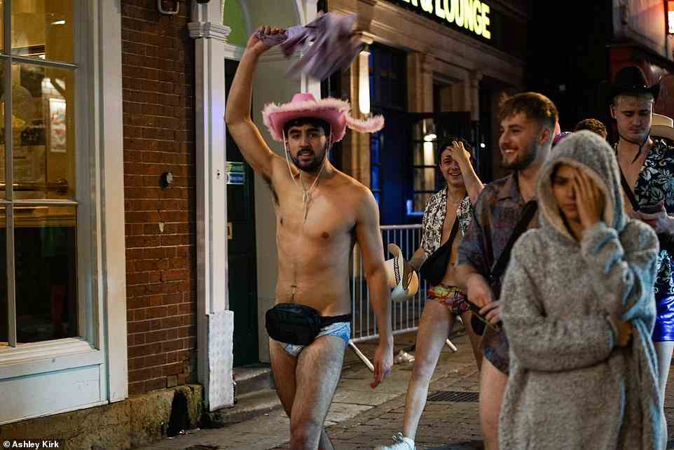 A man in a pink cowboy hat and blue y-fronts gets stuck into the Halloween night out in Nottingham