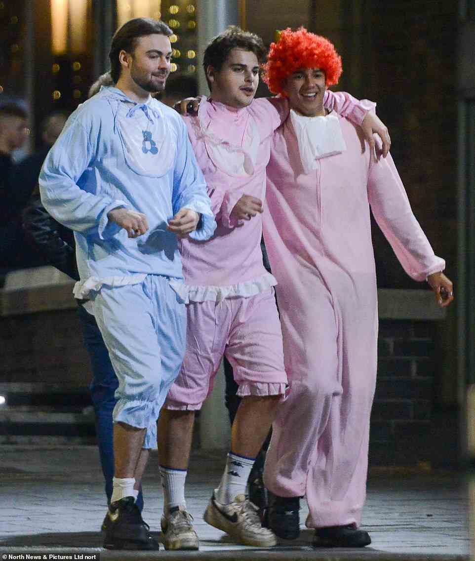 Three men dressed as babies walk around the streets of Newcastle late on Friday night