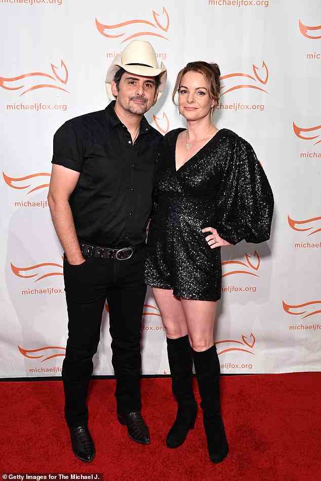 Country star: Country music star Brad Paisley, 50, stunned in a black button-down shirt, black jeans and a large black belt. He added a white cowboy hat to the look (pictured with wife Kimberly Williams-Paisley)