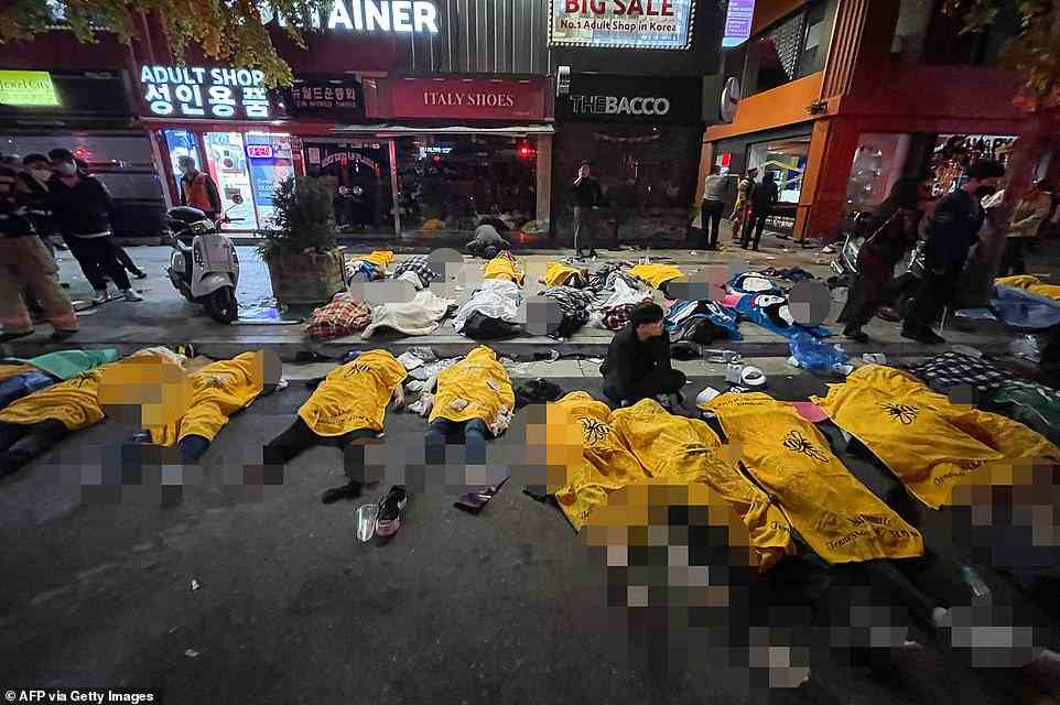 At least 25 bodies were left lying on the ground with makeshift shrouds to conceal them from public view in the immediate aftermath of the incident
