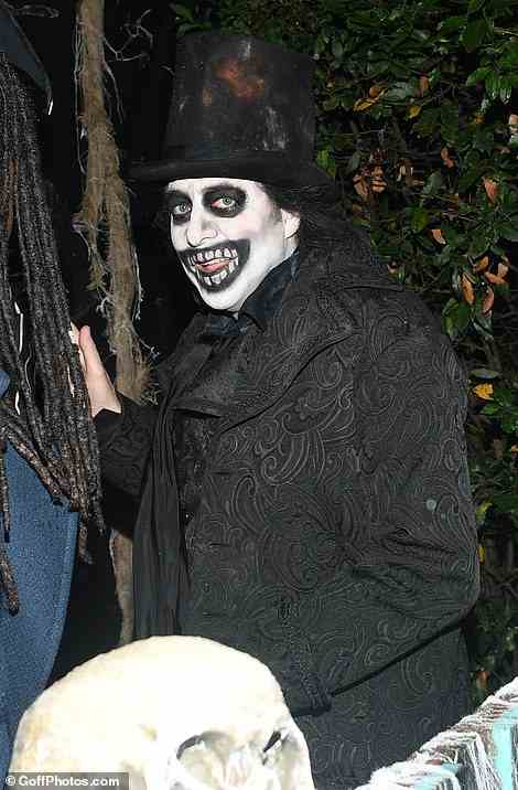 Ghoulish: Ross opted for skeletal white face paint and a gothic black outfit completed by a large top hat while welcoming youngsters outside the property he shares with wife Jane Goldman and their three children