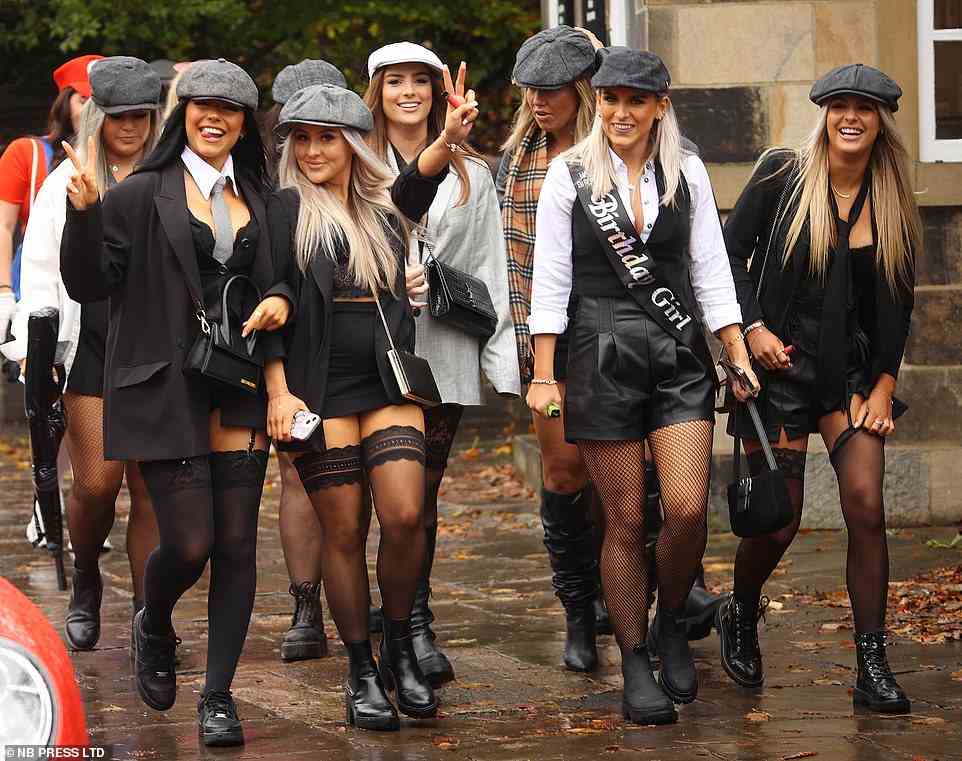 A group of women dressed as the Peaky Blinders power through the bad weather to keep the party going in Leeds today