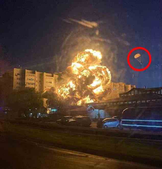 A Russian Su-34 fighter bomber jet crashed next to an apartment block in the city of Yeysk, setting the building on fire as the pilots ejected (circled)