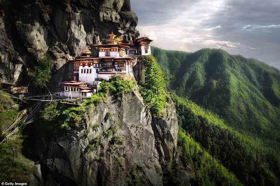 Holy ascent: On a tour of Bhutan, Ivo Dawnay climbs the steep track to the country's famous Tiger’s Nest monastery, which sits at 10,240ft (pictured)